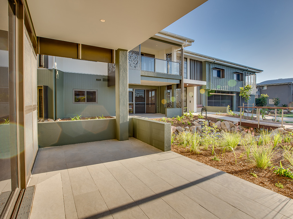 outdoor patio and landscaped gardens at Assisi apartments