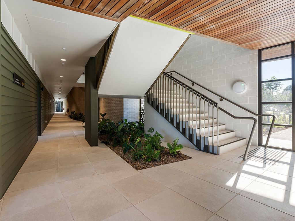 common hallway stairs and internal gardens at Assisi apartments