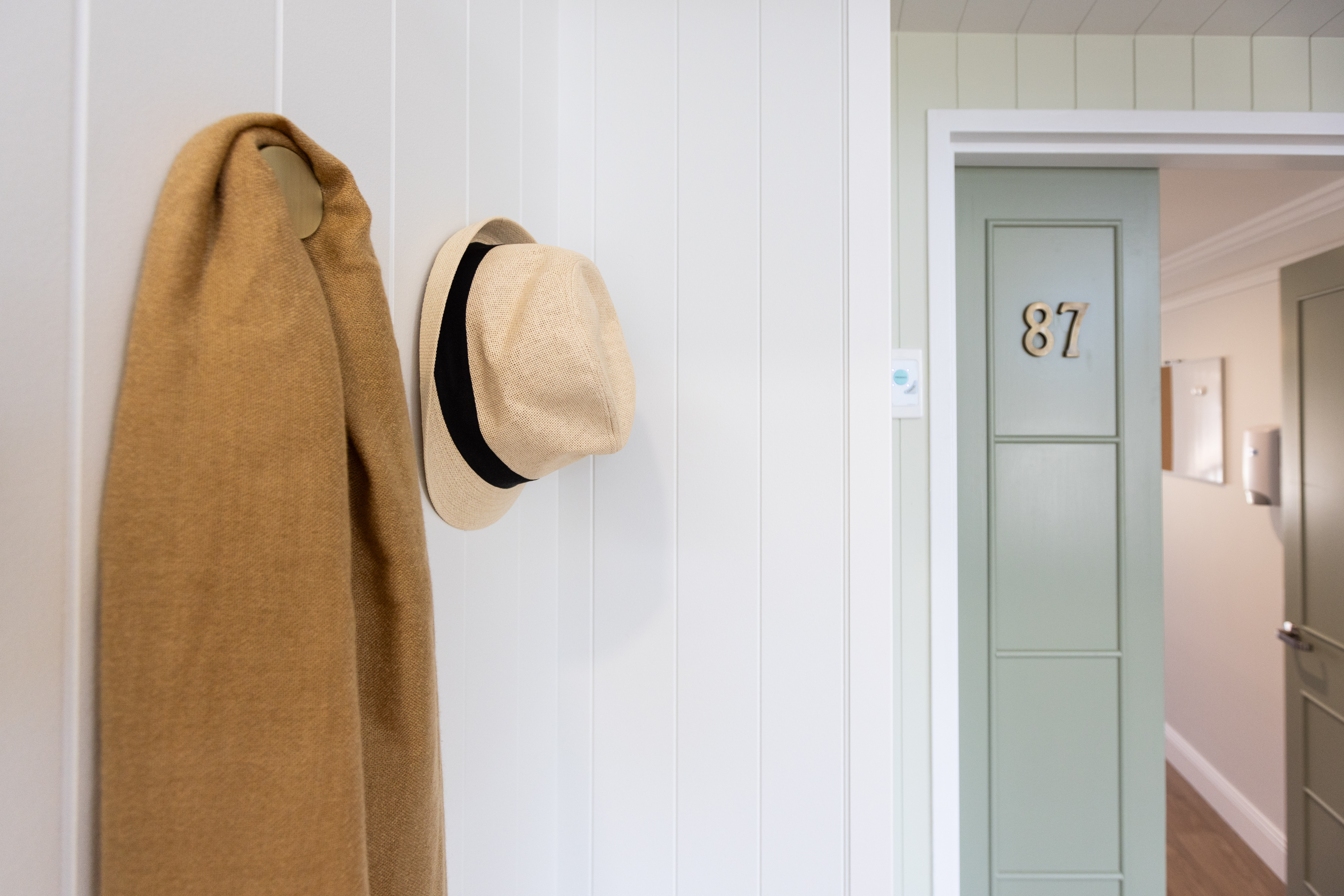 Residential Care room door with hat and scarf hanging on the wall