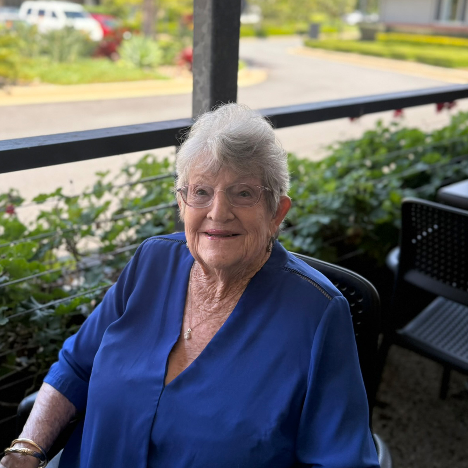 smiling resident sitting at Barneys Cafe verandah